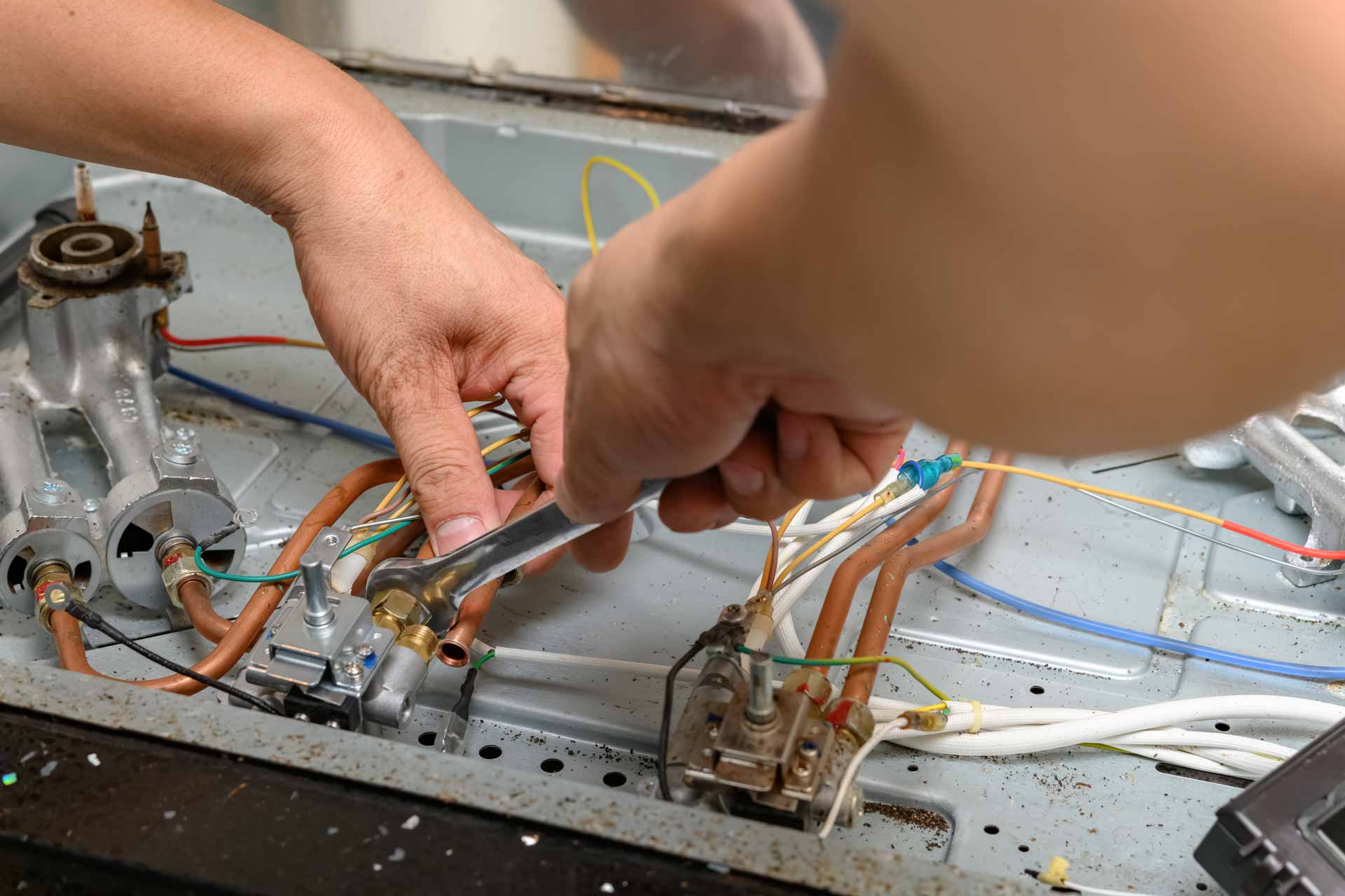 Appliance repair technician fixing gas stove