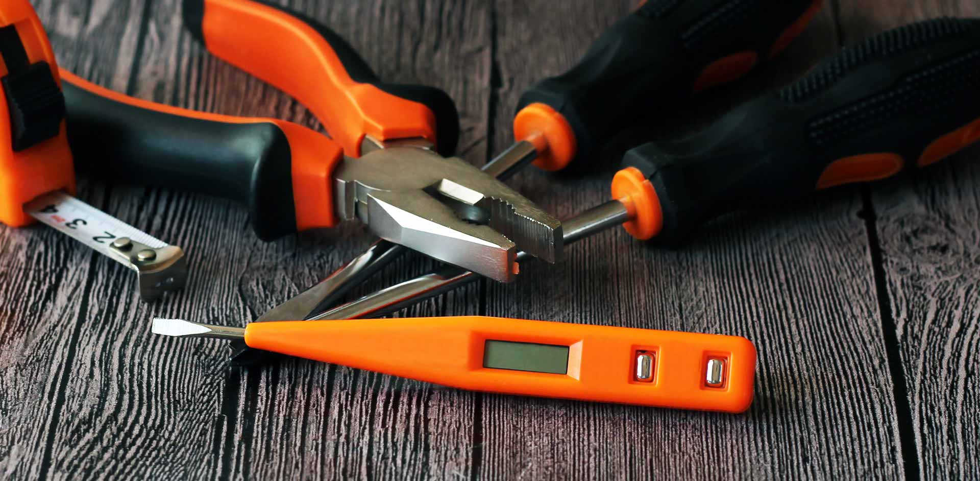 Orange repair tools on wooden bench
