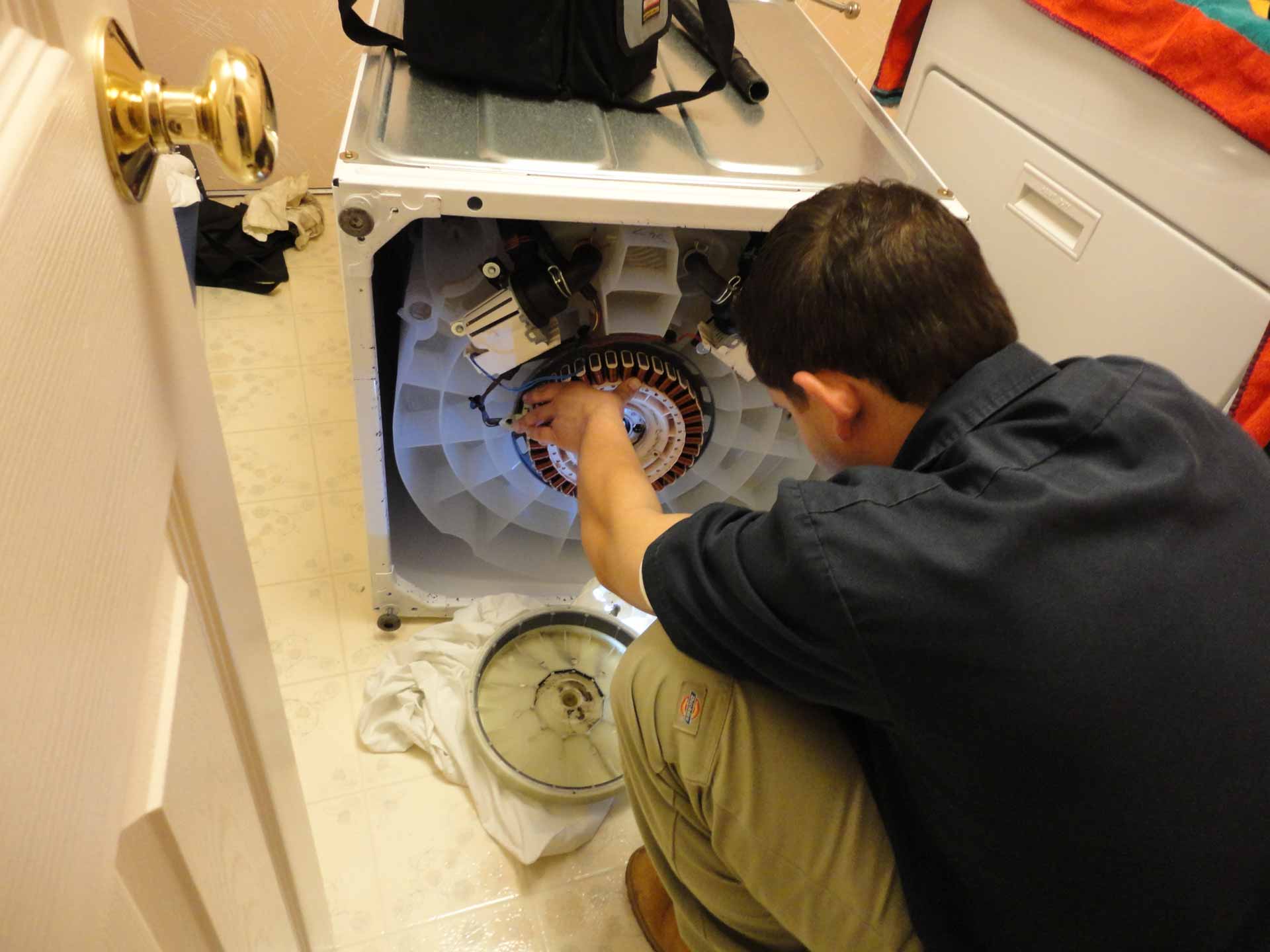 Technician from Manton Appliance Service working on a washing machine