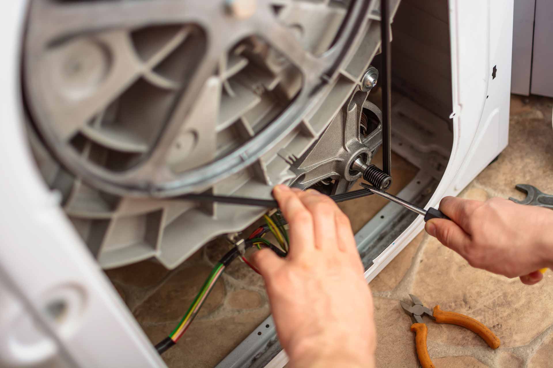 Appliance repair technician fixing a washing machine